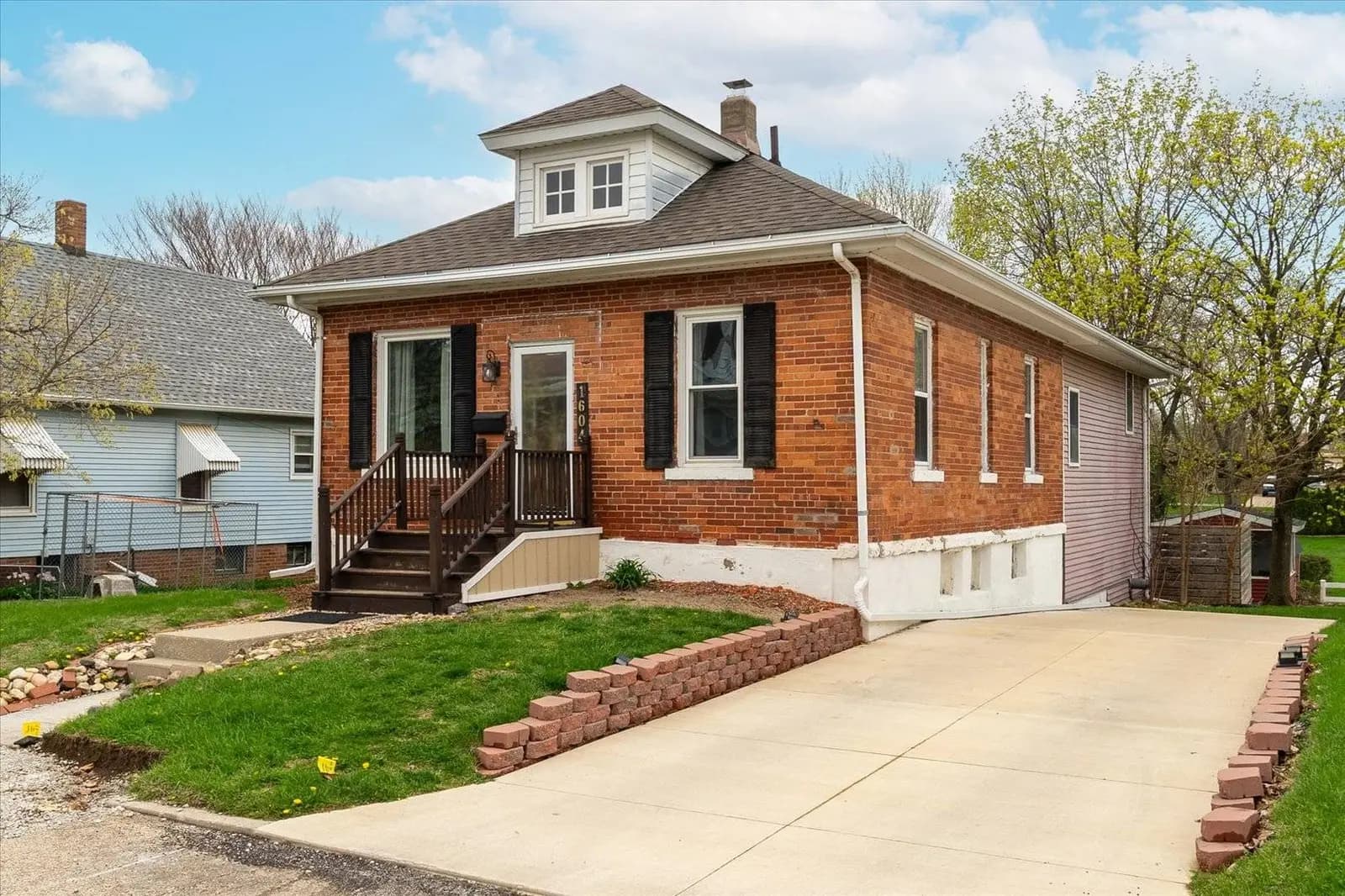 Heritage Hideaway from the driveway: brick exterior, rebuilt front porch and new driveway